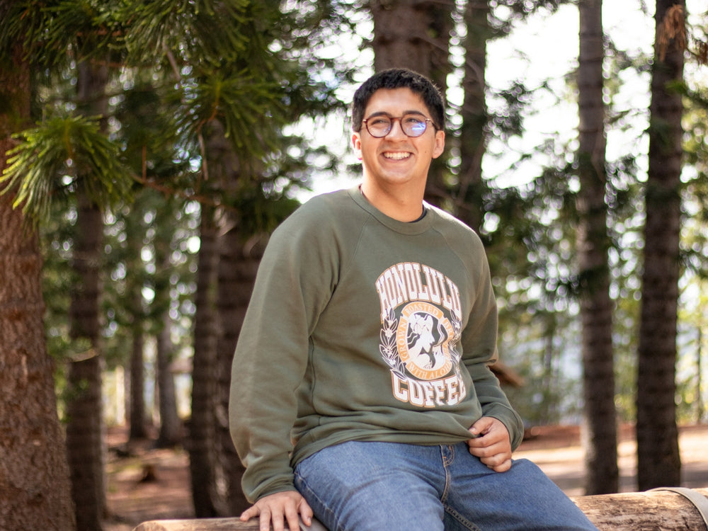 Man wearing Honolulu Coffee collegiate sweater 