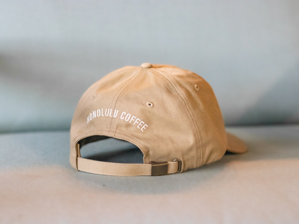 
                  
                    Back design of sand dune Shaka Dad Hat, featuring an embroidered "Honolulu Coffee"
                  
                