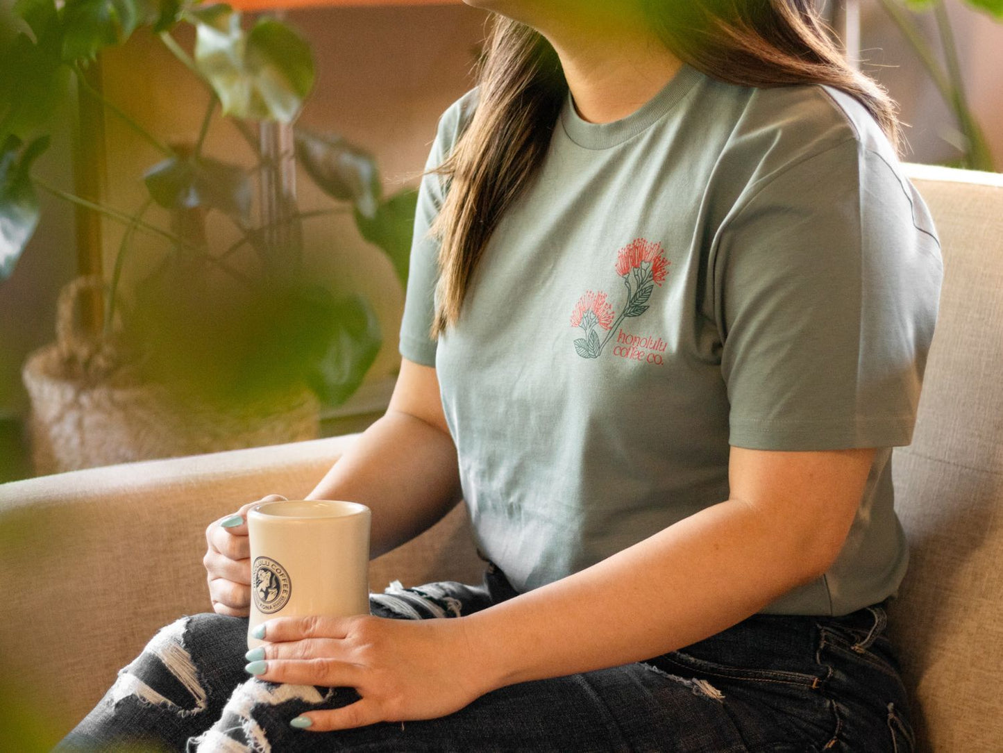 
                  
                    Woman with Honolulu Coffee merchandise
                  
                